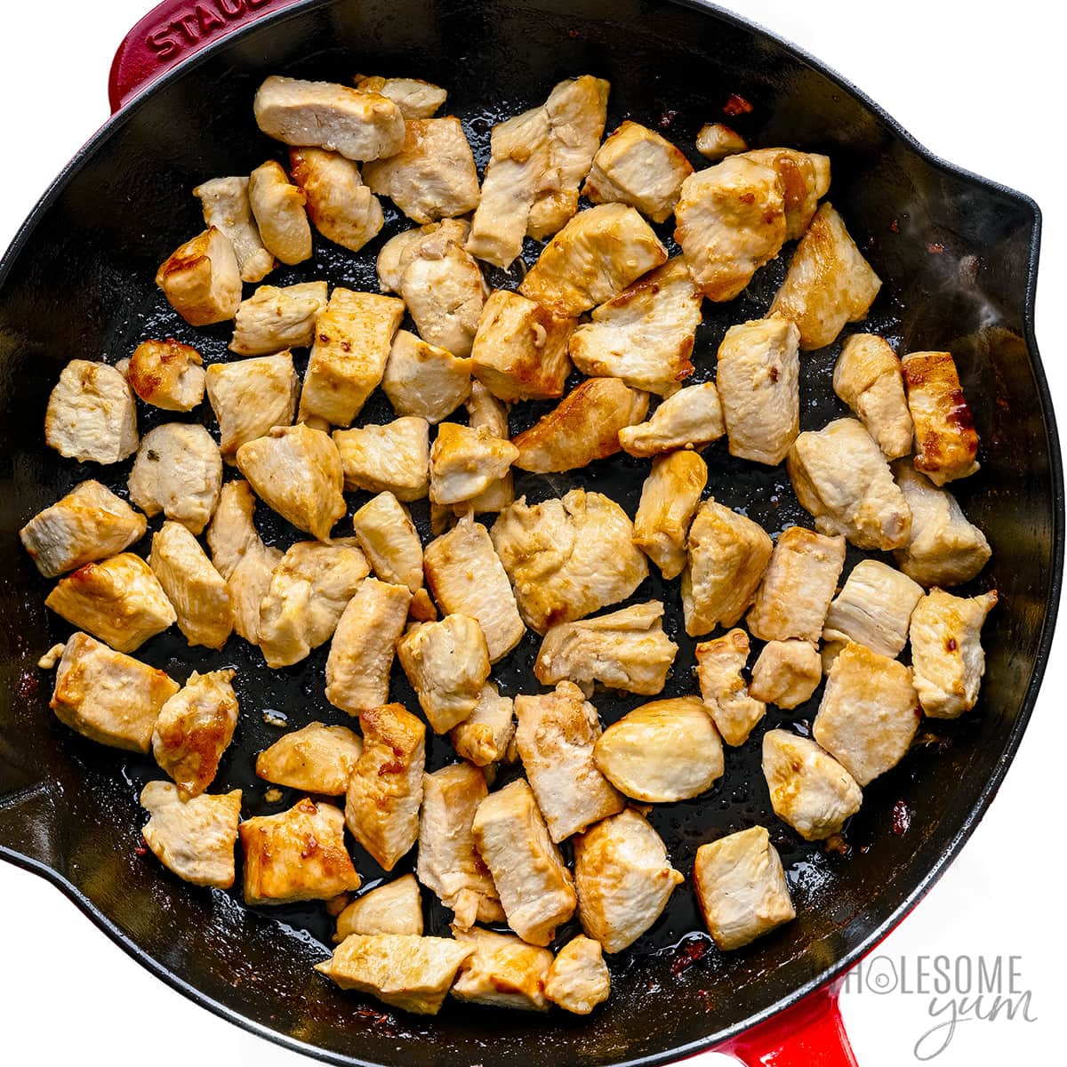 Chicken cooking in a skillet.